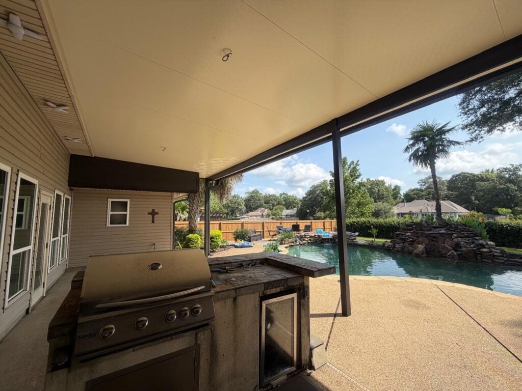 Covered outdoor kitchen under an aluminum patio cover