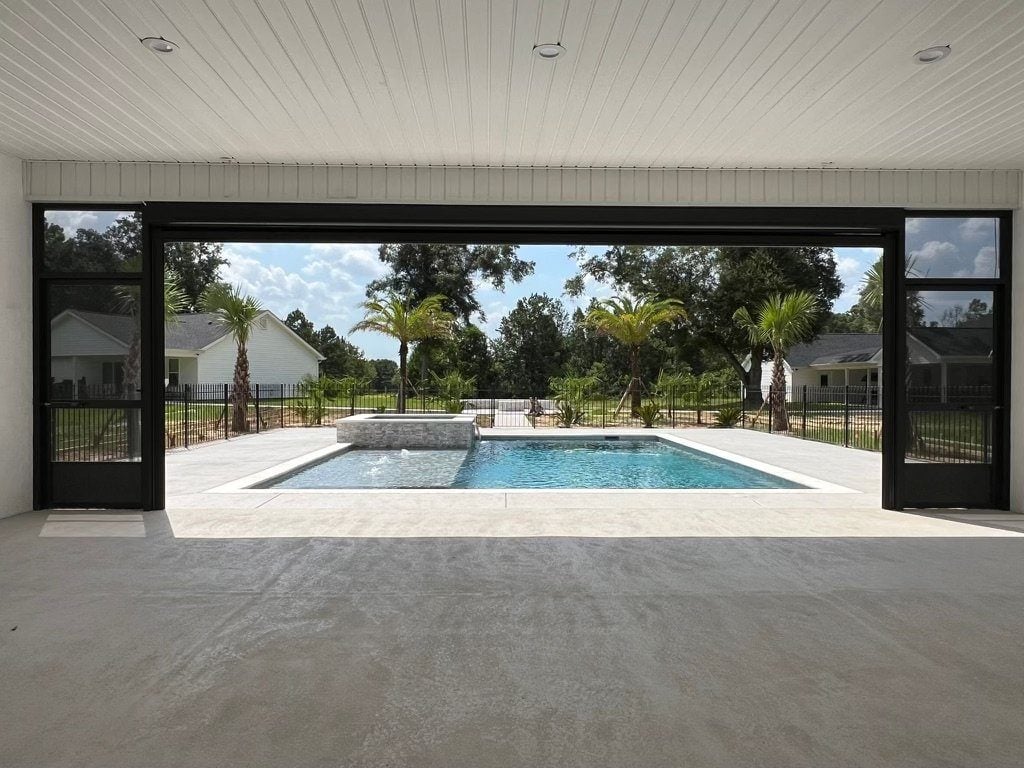Retractable roll-down screens opening to a pool