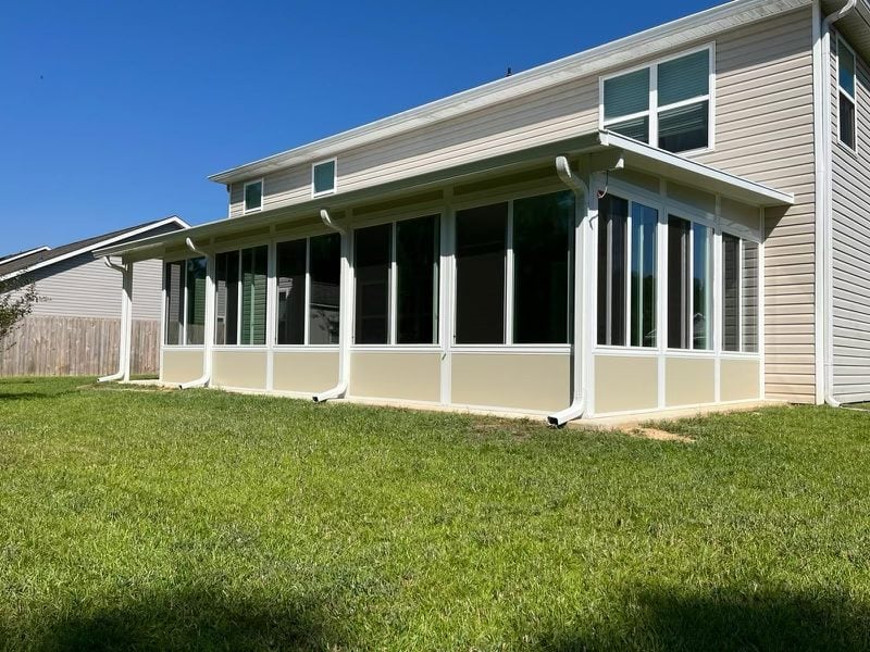 Sunroom addition with large windows